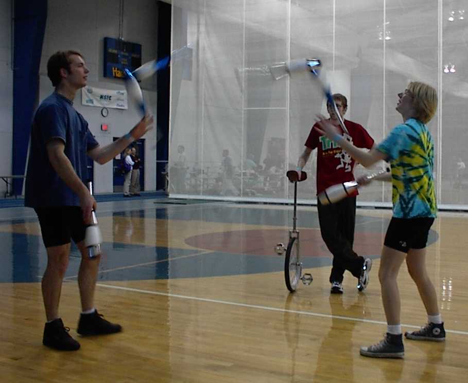 Peter and Tammy pass clubs as Johnny looks on.