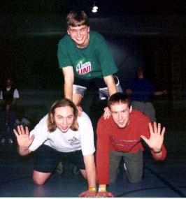 Simon Greenway from England and Brian Lecy from S.D. wave while Gilby poses on top.